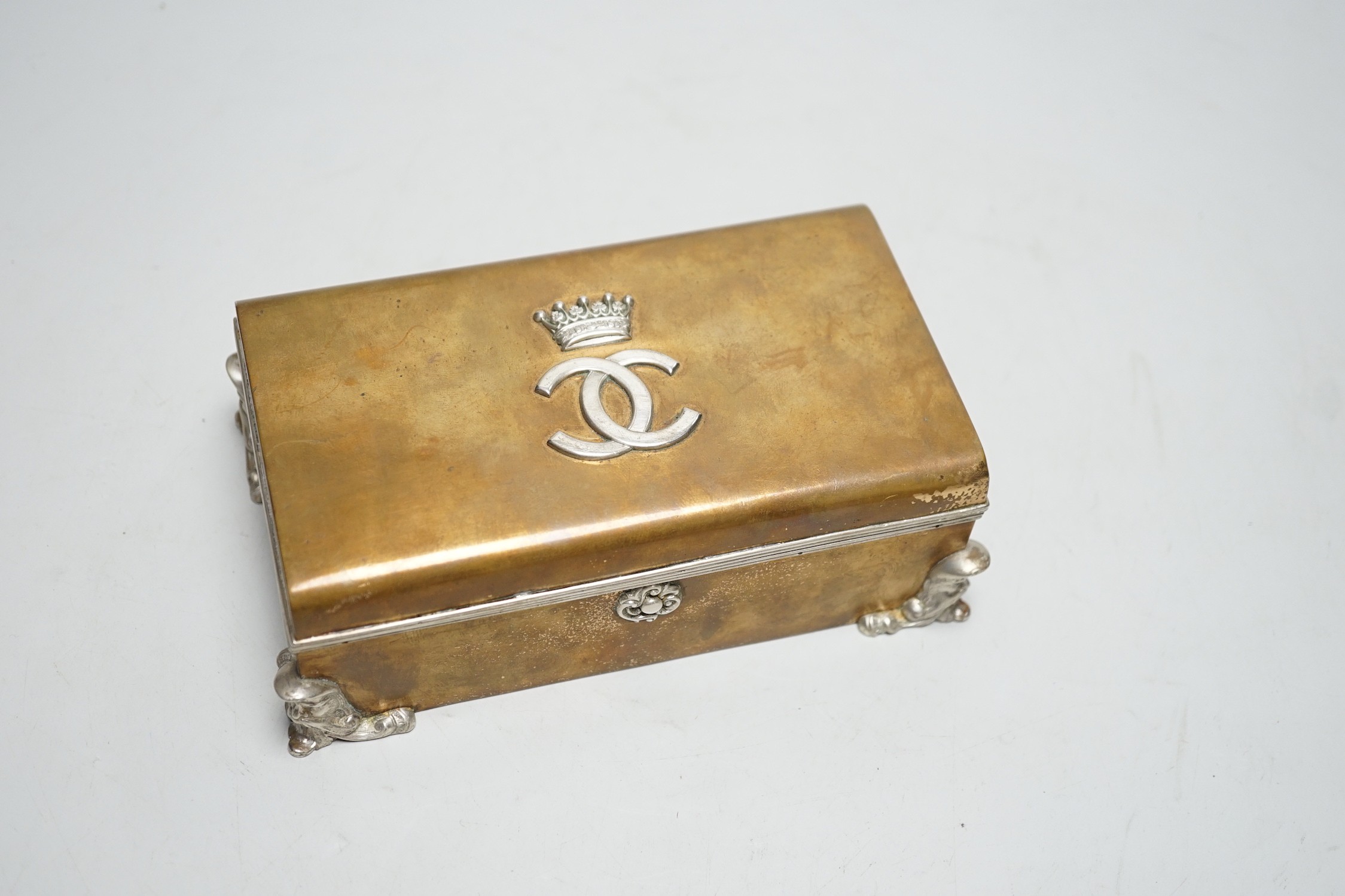 An unusual late Victorian silver mounted brass rectangular cigarette box, with applied monogram, Alfred Fuller, London, 1885, 16.4cm.